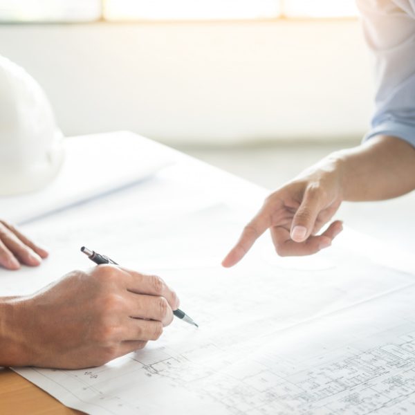 close-up-person-s-engineer-hand-drawing-plan-blue-print